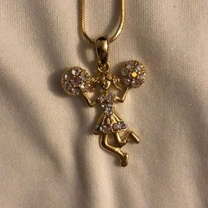 A gold colored cheer necklace